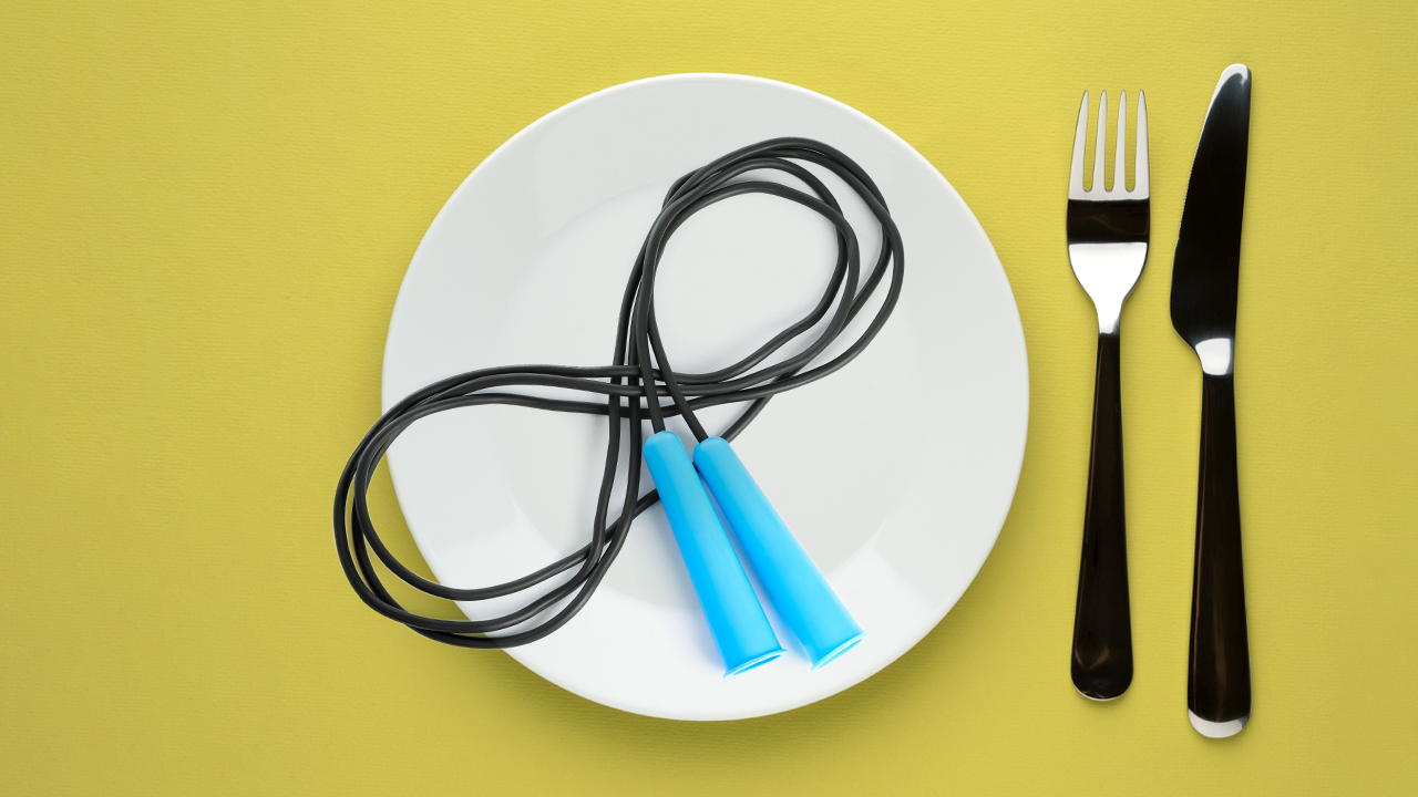 skipping ropes on a plate with a silver knife and fork to the side on a yellow background