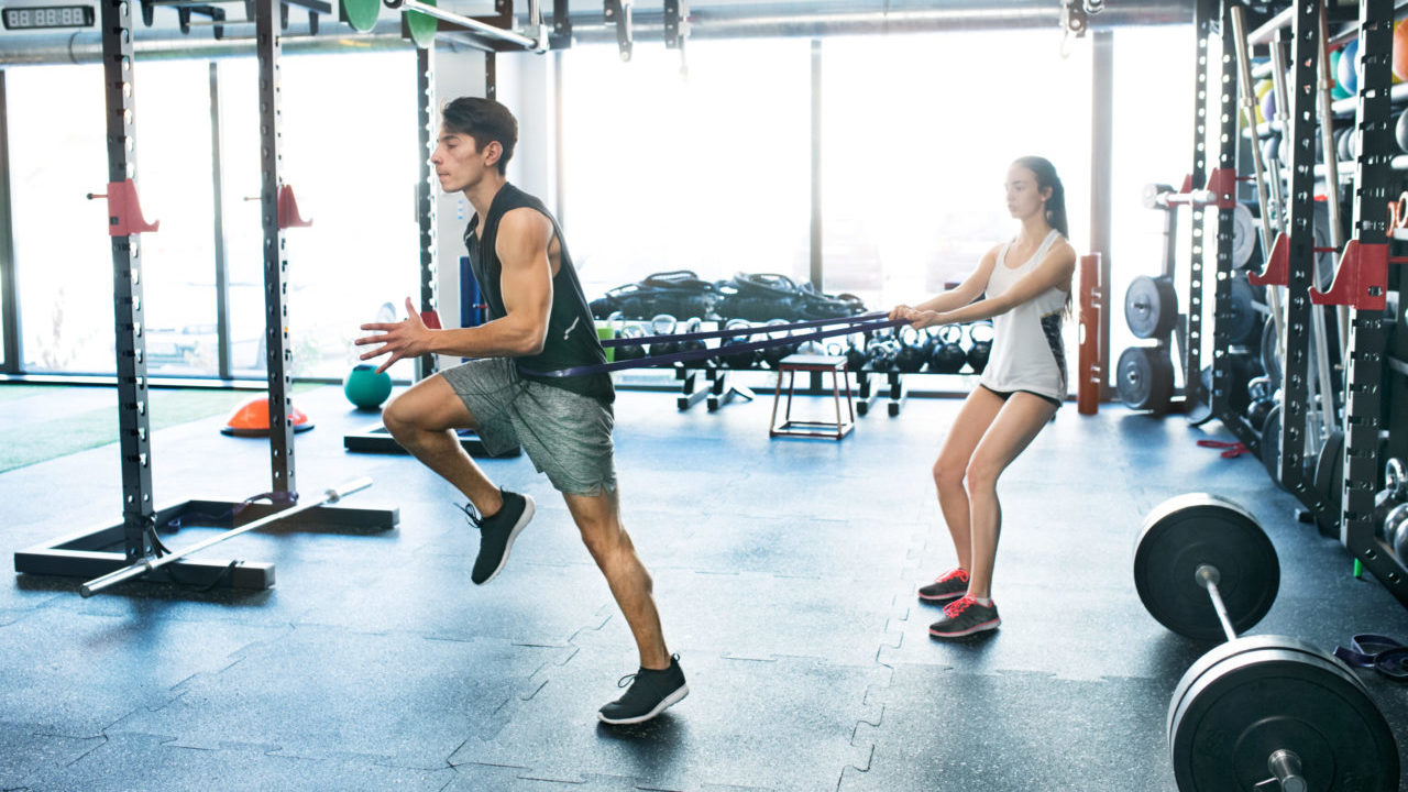 Strong man using a resistance band in his exercise routine.